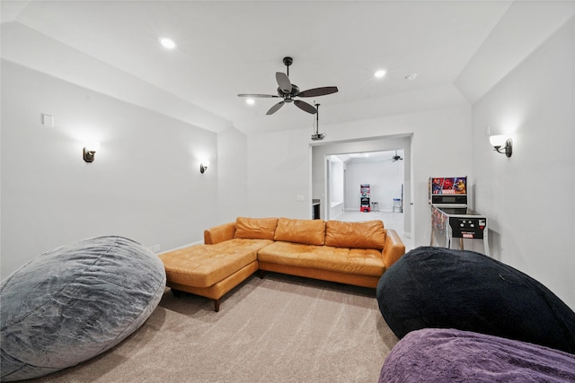 carpeted living room featuring vaulted ceiling and ceiling fan