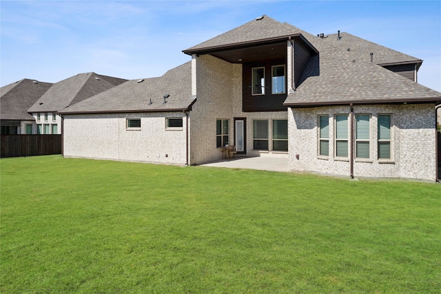 rear view of house with a patio and a lawn