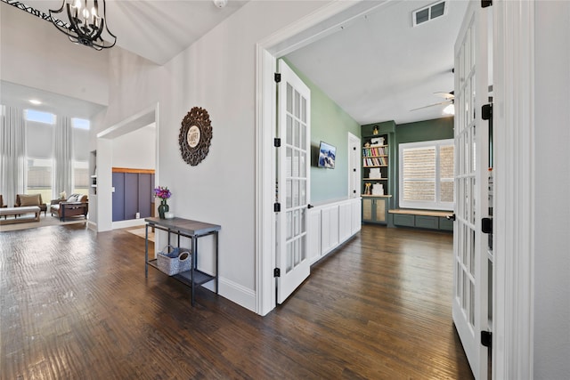 hall with french doors, plenty of natural light, and dark hardwood / wood-style floors