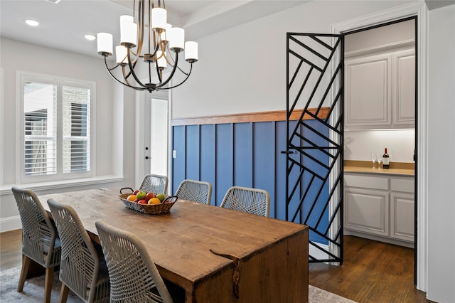 dining space with an inviting chandelier and dark hardwood / wood-style floors