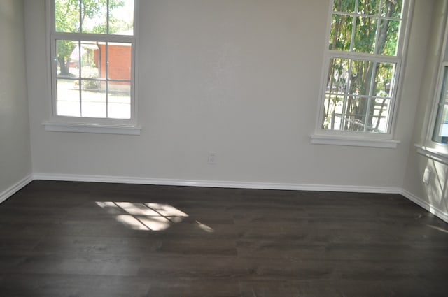 spare room featuring dark hardwood / wood-style flooring