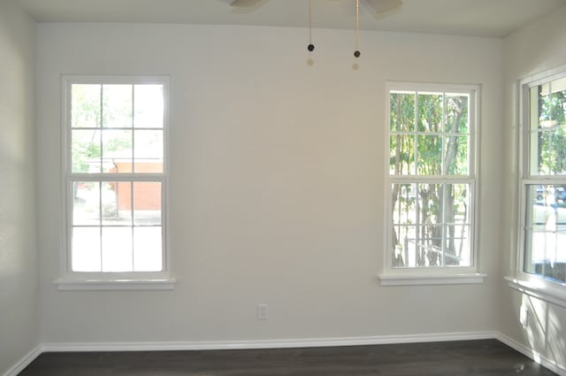 empty room featuring dark hardwood / wood-style flooring and ceiling fan