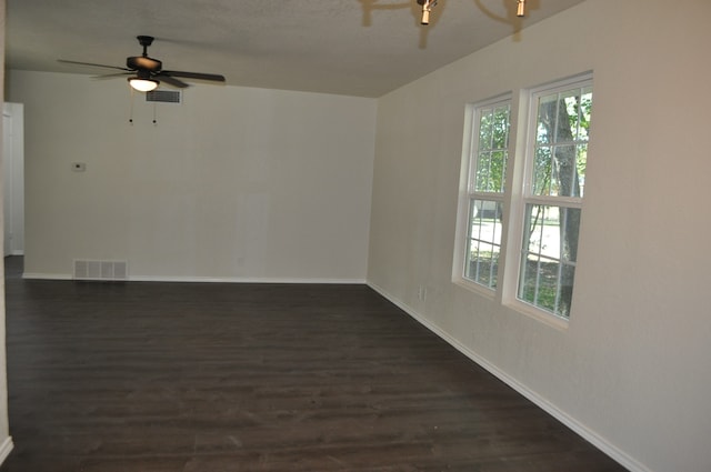 unfurnished room featuring ceiling fan and dark hardwood / wood-style flooring