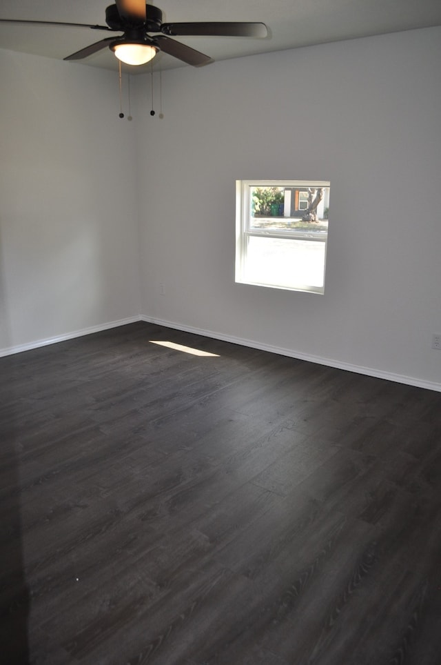 empty room featuring dark hardwood / wood-style floors and ceiling fan