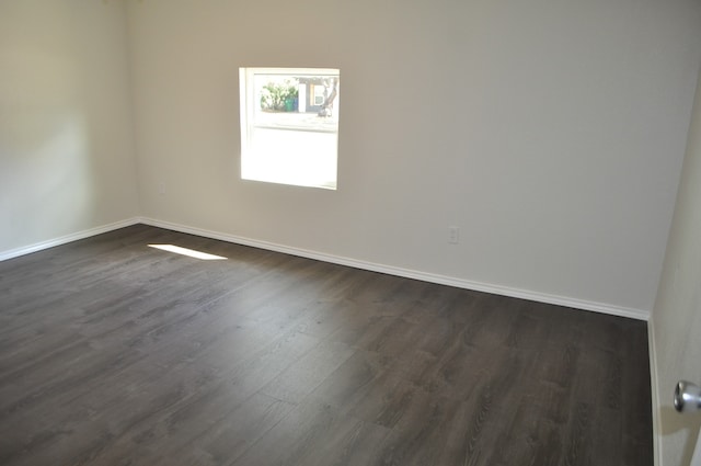 spare room with dark hardwood / wood-style floors