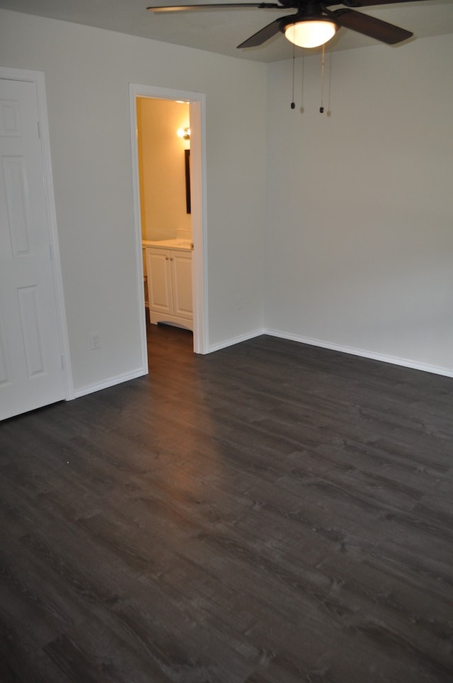 empty room with dark wood-type flooring and ceiling fan