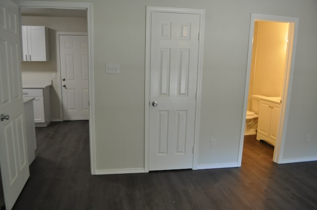 bedroom featuring dark hardwood / wood-style floors and ensuite bathroom