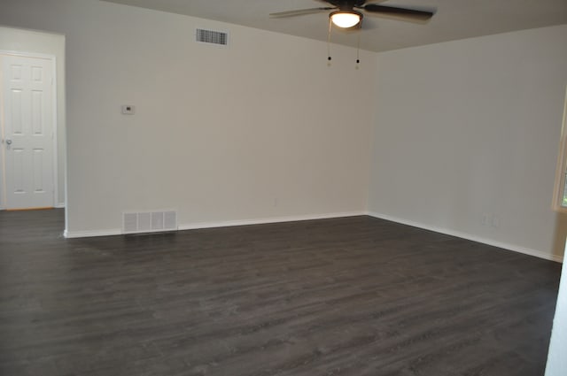 spare room with ceiling fan and dark hardwood / wood-style floors