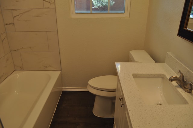 bathroom with vanity, hardwood / wood-style floors, toilet, and a bathing tub