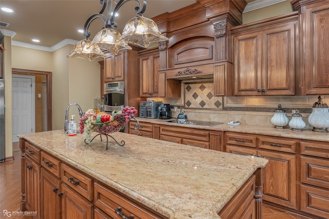 kitchen featuring tasteful backsplash, ornamental molding, appliances with stainless steel finishes, decorative light fixtures, and light stone countertops