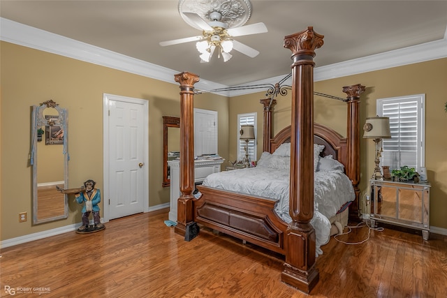 bedroom with hardwood / wood-style floors, ceiling fan, and ornamental molding