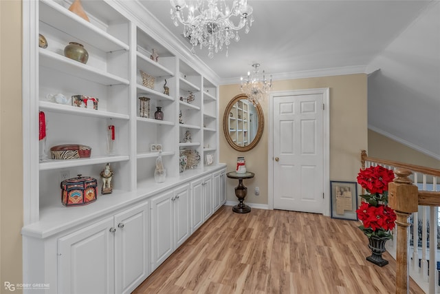 interior space featuring light hardwood / wood-style floors, a notable chandelier, and crown molding