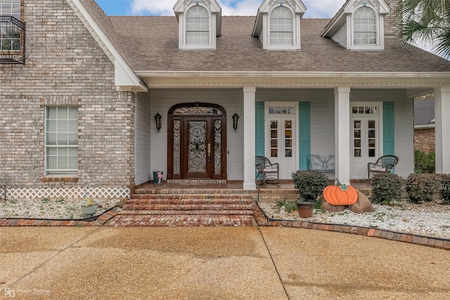 doorway to property featuring covered porch