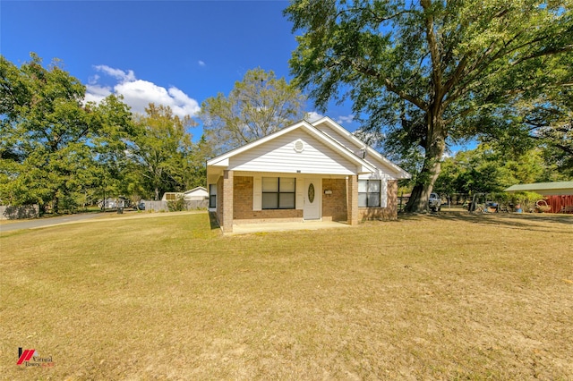 bungalow-style home with a porch, brick siding, and a front lawn