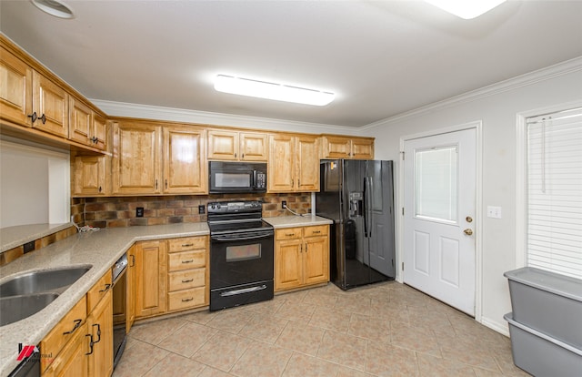 kitchen with tasteful backsplash, light tile patterned floors, black appliances, crown molding, and sink