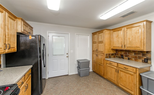 kitchen featuring black appliances, crown molding, and tasteful backsplash