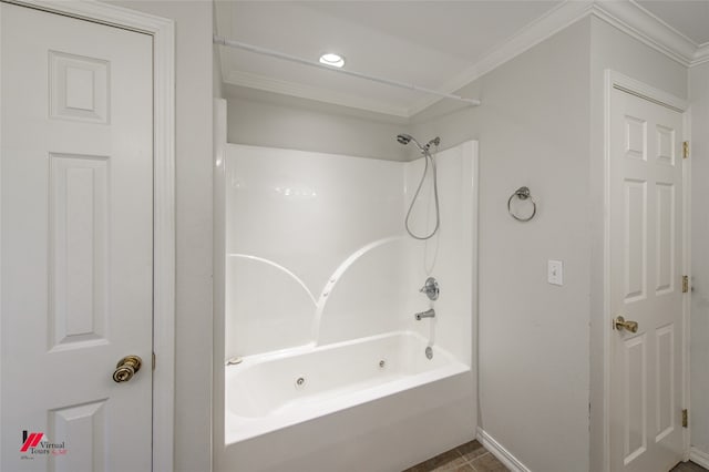 bathroom with ornamental molding and bathing tub / shower combination