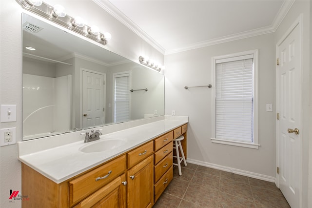 bathroom with vanity, crown molding, and tile patterned flooring