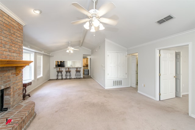 unfurnished living room with ornamental molding, vaulted ceiling, light carpet, and ceiling fan