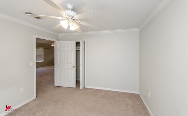 carpeted empty room with crown molding and ceiling fan