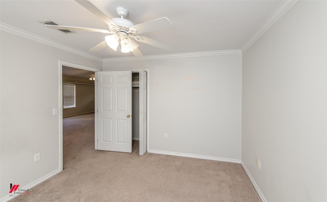 unfurnished bedroom featuring crown molding, baseboards, and light colored carpet