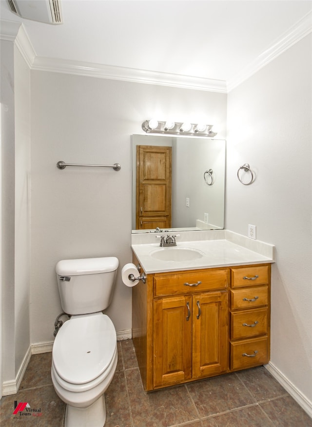 bathroom featuring vanity, ornamental molding, toilet, and tile patterned flooring