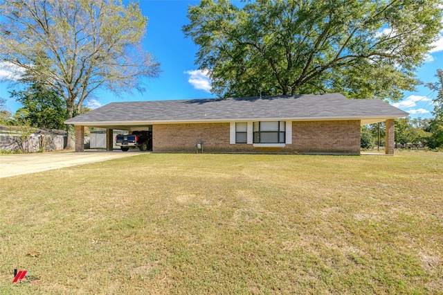ranch-style house with brick siding, a carport, a front yard, and concrete driveway