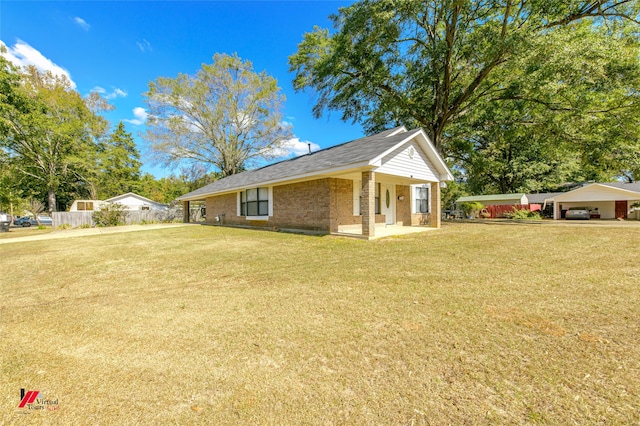 view of side of property featuring a yard and a carport