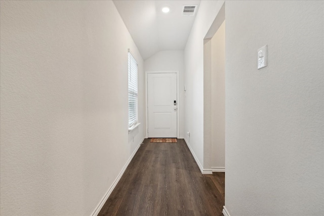 corridor featuring dark wood-type flooring and vaulted ceiling