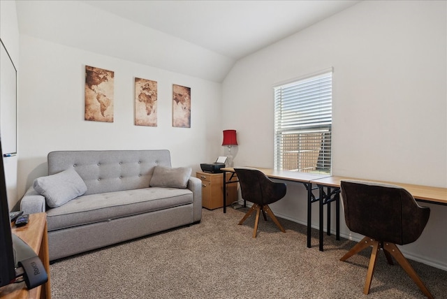 carpeted home office featuring built in desk and vaulted ceiling