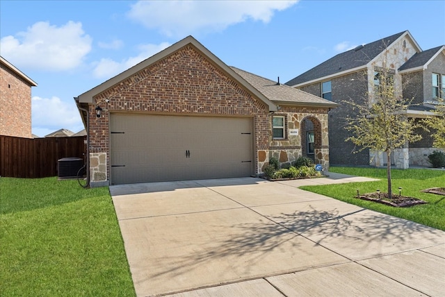 view of front of home featuring a front yard, a garage, and central AC unit