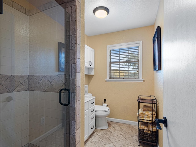 bathroom featuring vanity, tile patterned flooring, toilet, walk in shower, and a textured ceiling