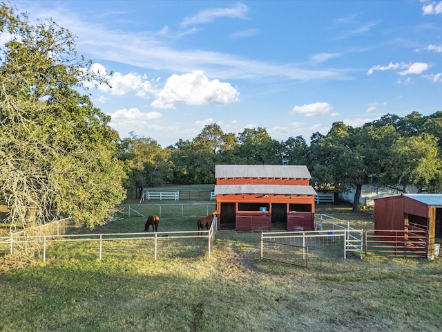 view of horse barn featuring a rural view