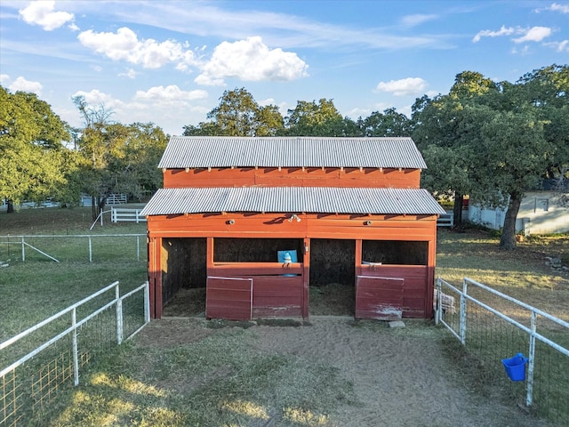 view of stable with a rural view