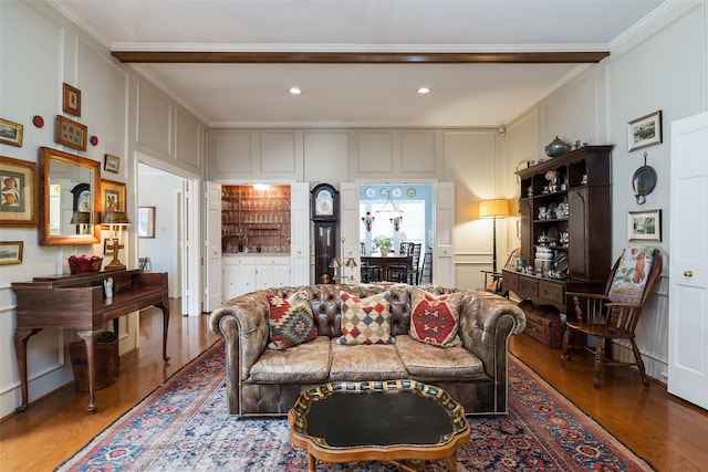 living room featuring crown molding and hardwood / wood-style flooring