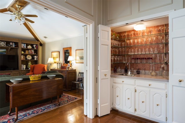 bar featuring vaulted ceiling, sink, dark hardwood / wood-style floors, and white cabinets