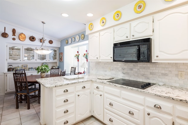 kitchen with lofted ceiling, white cabinets, black appliances, and kitchen peninsula