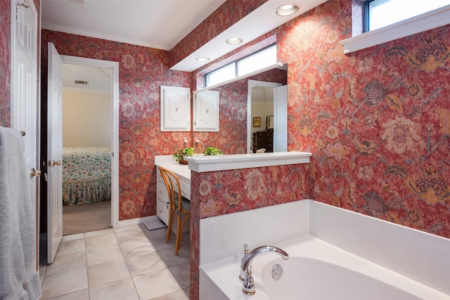 bathroom featuring a bathtub, ornamental molding, tile patterned flooring, and vanity