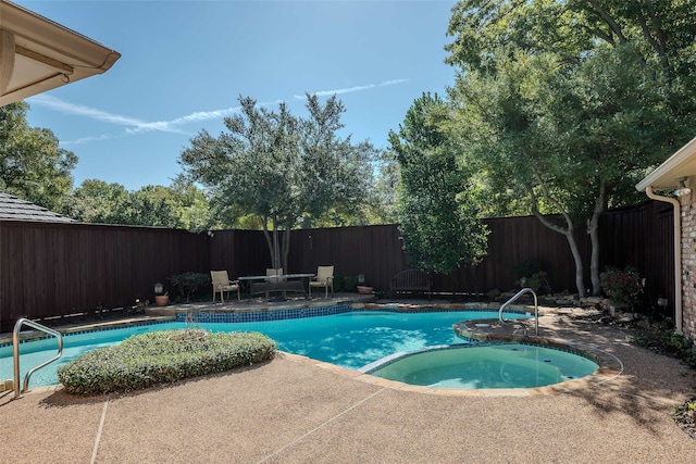 view of pool featuring an in ground hot tub and a patio area