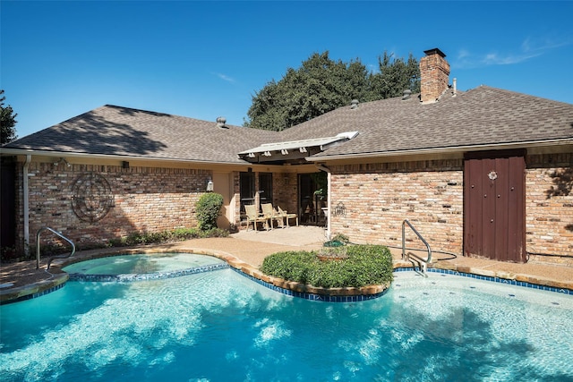 view of swimming pool with a patio area and an in ground hot tub