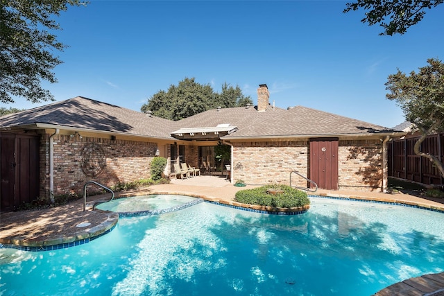 view of pool featuring an in ground hot tub and a patio area