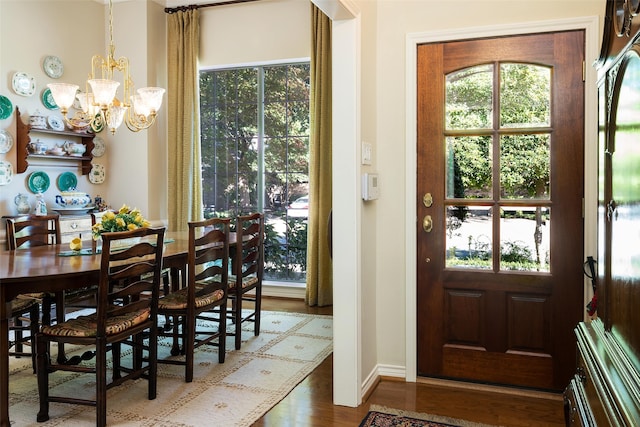 dining area with a notable chandelier and hardwood / wood-style flooring