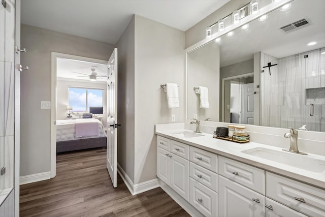 bathroom with vanity, walk in shower, hardwood / wood-style flooring, and ceiling fan