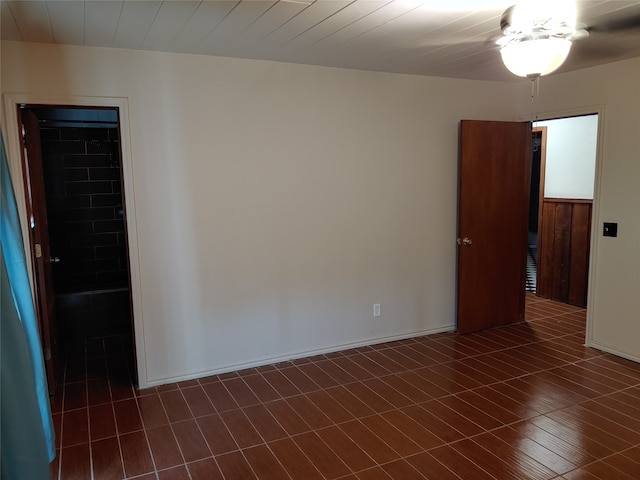 empty room featuring dark hardwood / wood-style flooring and ceiling fan