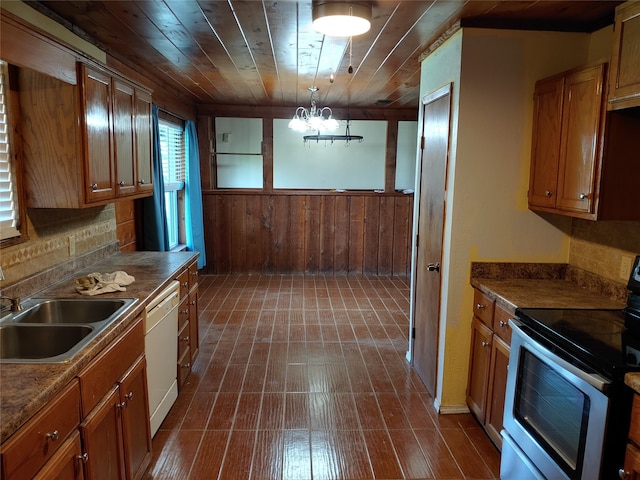 kitchen featuring decorative backsplash, wooden ceiling, wood walls, decorative light fixtures, and white appliances