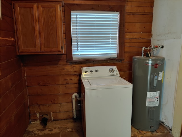 laundry room with washer / dryer, wood walls, water heater, and cabinets