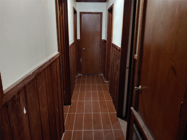 corridor featuring wood walls