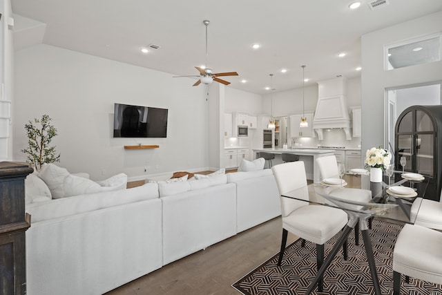 living room featuring ceiling fan and hardwood / wood-style floors