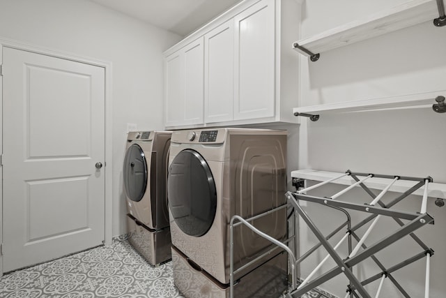 laundry room featuring washing machine and dryer and cabinets