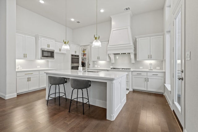 kitchen with sink, appliances with stainless steel finishes, dark wood-type flooring, and white cabinetry